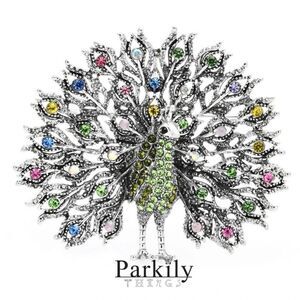 Brooch peacock in sparkly green and multicolor crystals in a silver pin setting